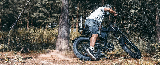 Man riding black Riding'times Z8 Pro electric bike off-road in forest terrain