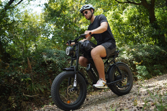 A man riding black off-road electric bike in the mountain