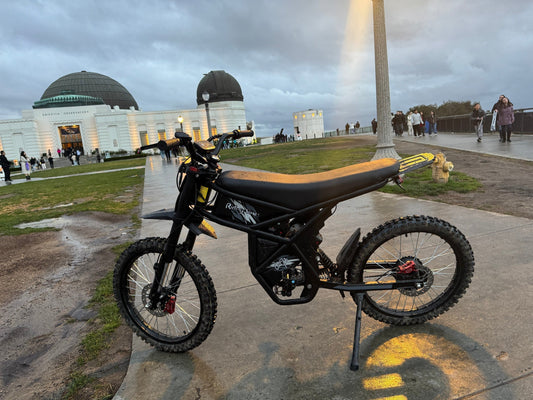 Modern black electric bike parked near iconic observatory showcasing advancements in the bike industry
