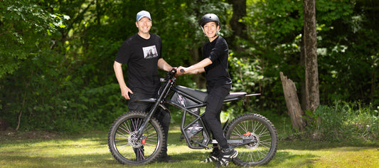 A happy father and son with a Riding Times electric bike, showcasing the family safety and peace of mind provided by our E-Bike Liability Protection.