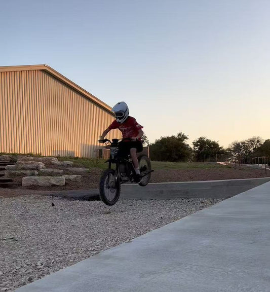 Person riding an electric bike over gravel at sunset highlighting tariffs impact on ebike prices and spring riding benefits