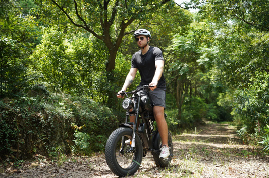 Man wearing helmet riding a Z8 Series electric bike on a forest trail surrounded by greenery