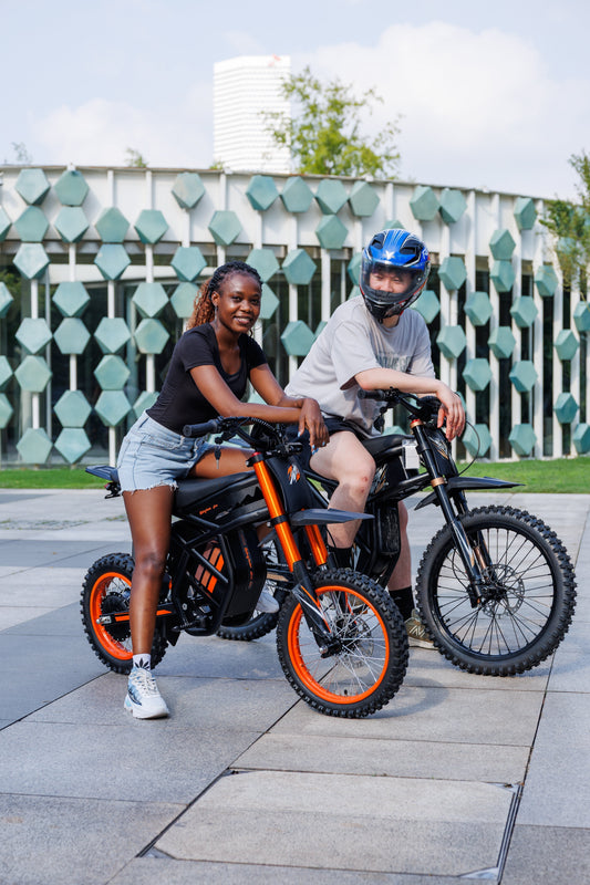 Two riders with Riding Times GT54 electric bikes, urban outdoor setting, modern design, one wearing helmet