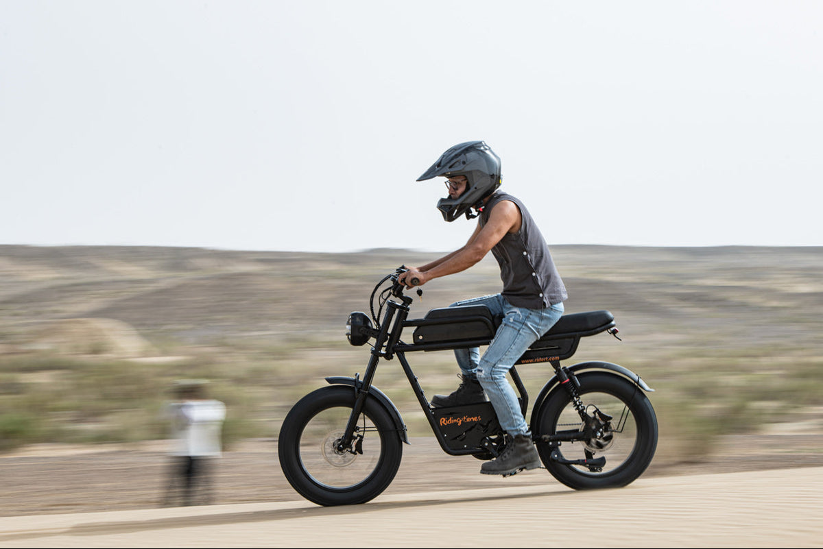 Person riding a GT33 on a road with a blurred background