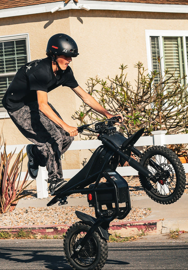 Person riding a GT54Pro electric bike on a residential street