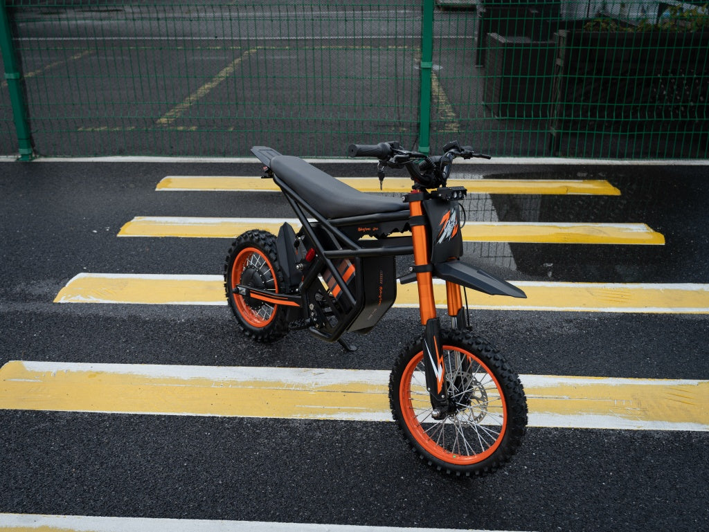 GT54 electric mini motorbike in black and orange designed for kids and adults with off-road tires and high-performance motor