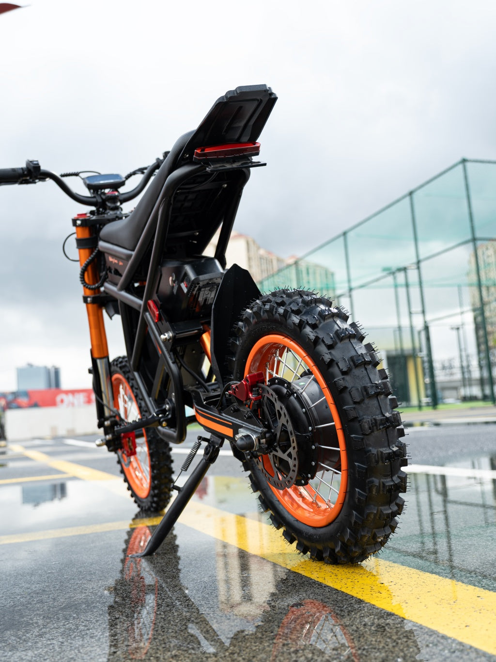 GT54 electric mini motorbike with 2000W motor and off-road tires on wet urban street