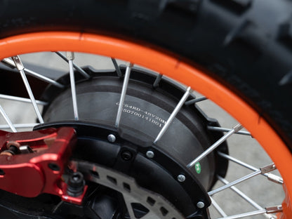 Close-up of GT54 2000W electric motor on orange-rimmed mini motorbike wheel.