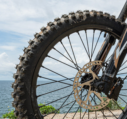 Off-road bike tire and inner tube with knobby tread near the sea