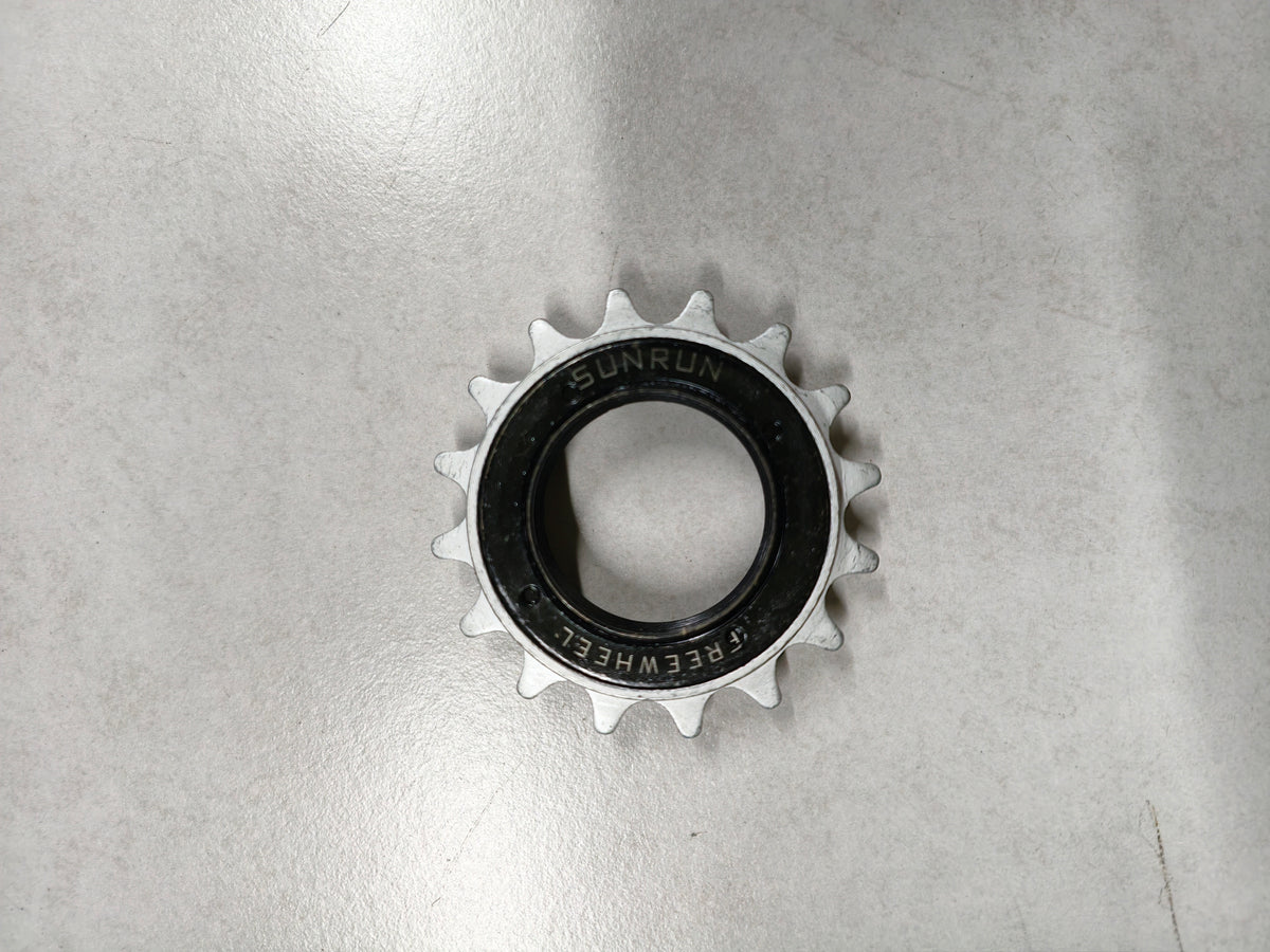 Metallic sprocket on a reflective gray surface