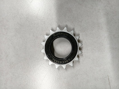 Metallic sprocket on a reflective gray surface