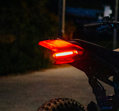 Bright red LED brake light mounted on rear of bicycle for enhanced night visibility and safety