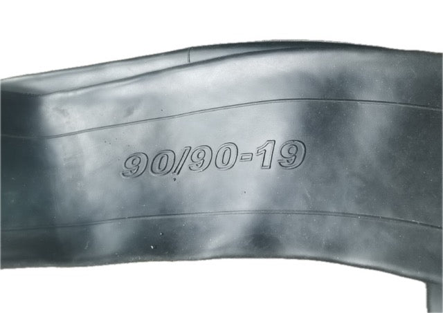 Close-up of tire and inner tube with 90/90-19 size marking