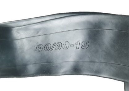 Close-up of tire and inner tube with 90/90-19 size marking