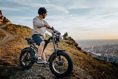 Person riding a Z8 on a hill with a cityscape in the background