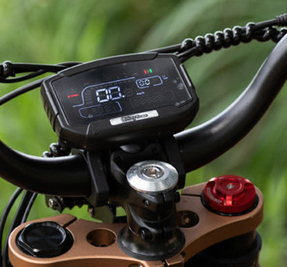 LCD display screen mounted on bike handlebar showing speed and battery level for cycling information