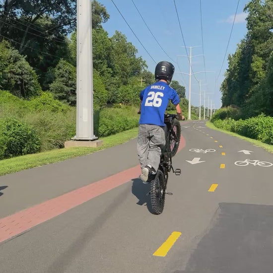 GT73 Pro electric dirt bike rider standing on footpegs for a cool freestyle ride - Superior balance and control