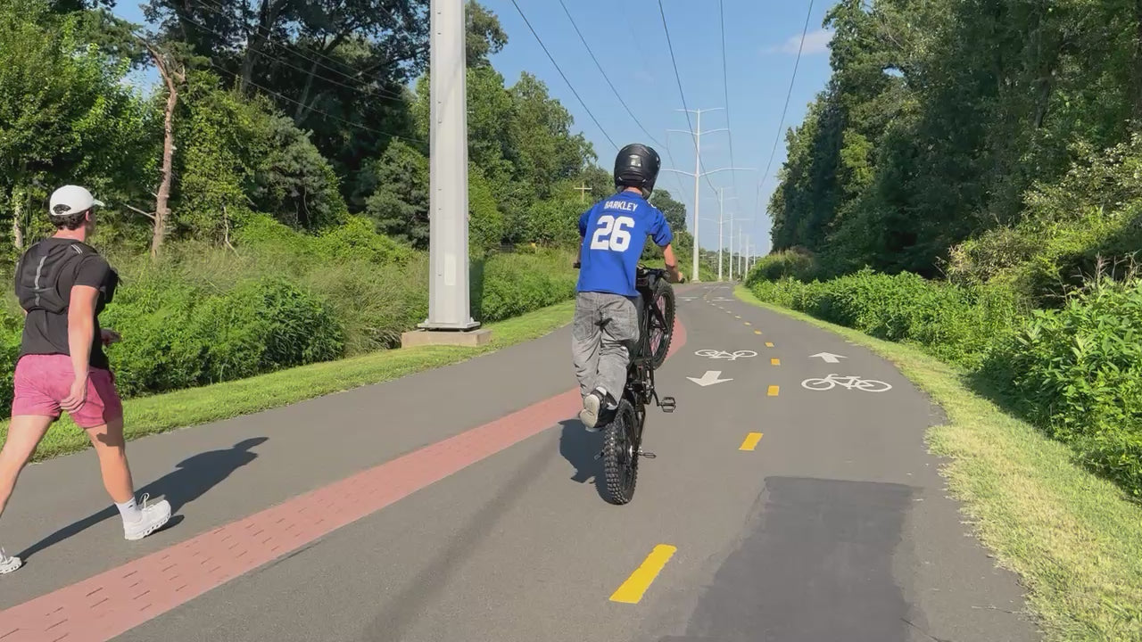 GT73 Pro electric dirt bike rider standing on footpegs for a cool freestyle ride - Superior balance and control
